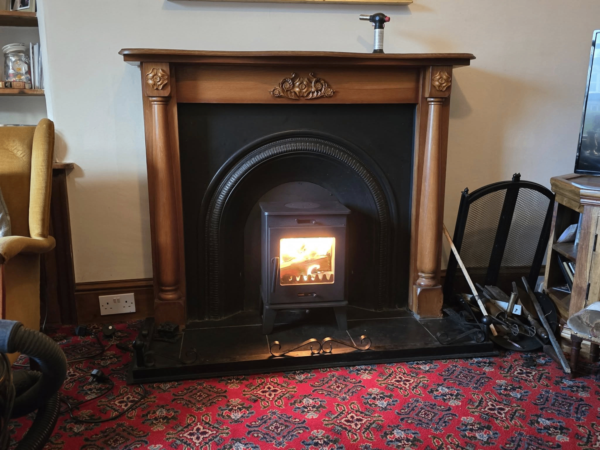 Inset stove installed in classic timber mantel