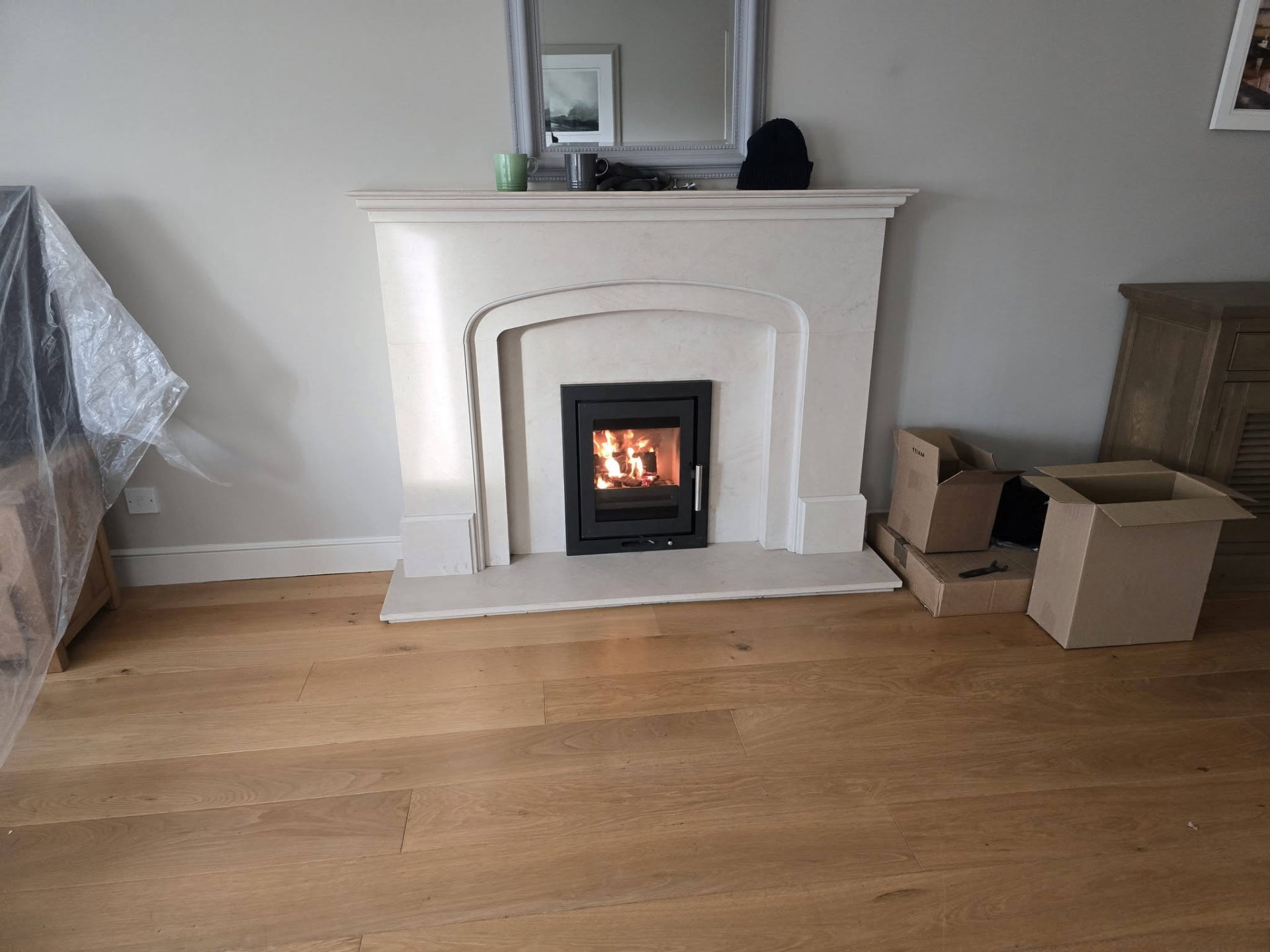 Inset stove installation in marble fireplace surround
